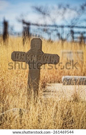Single worn out stone grave marker with unknown text