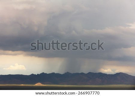 Rain storm near mountain range in Arizona desert