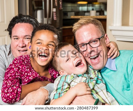 Gay parents and their children pose for a photo at home