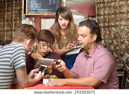 Rude diners ignoring waitress in a coffee house