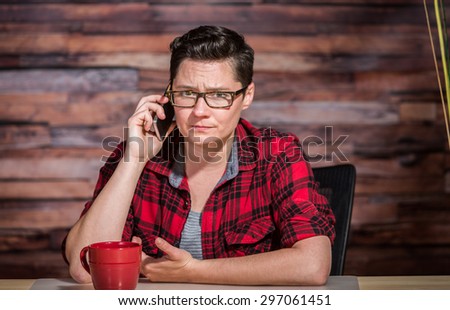 Mad office worker at modern desk office on phone