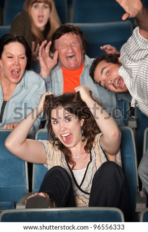 Group of people in audience scream in terror