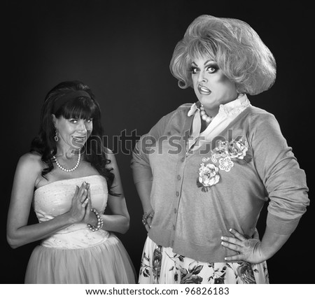 Innocent woman and disgusted drag queen over red background