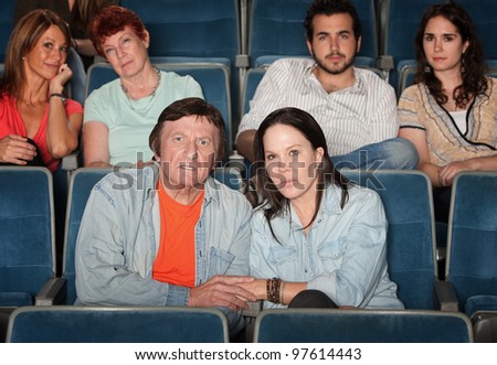 Group of upset audience watch movie in theater