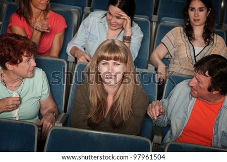 Weeping woman and distracted people in the audience