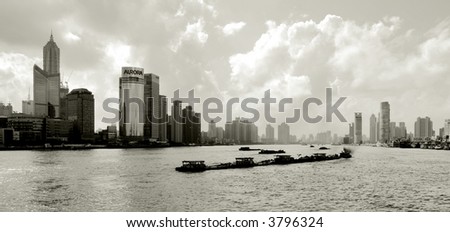 barge transportation in Shanghai with view of skyscrapers in Pudong area, Shanghai, China