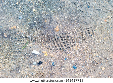 Shoe prints in loose sand. Dry soil shoeprints.