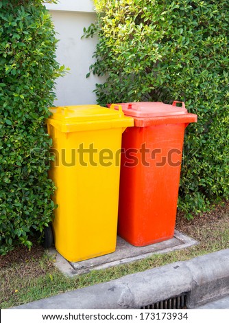 Yellow and  red clean garbage bin