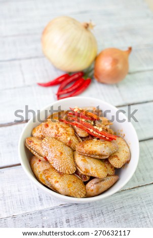 Stir fried clams with roasted chili paste is Thailand food on the wooden table