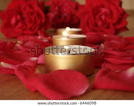 rose and candle. candlelight with rose on mirror.