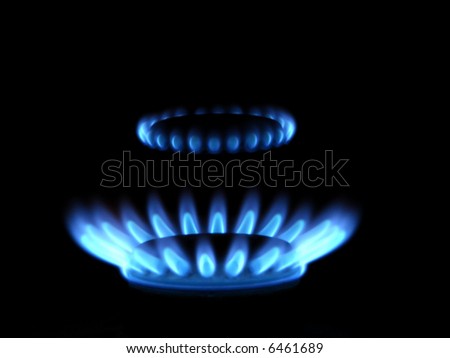 stock photo Blue flames of gas stove in the dark