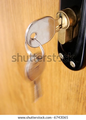 A hotel room door lock and key.