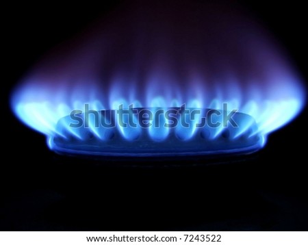 Blue flames of gas stove in the dark