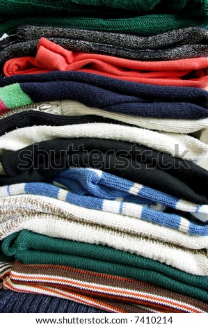 Heap of sweaters of clothes on a whiteness