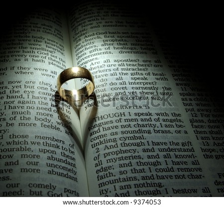 stock photo Wedding Ring and heart shaped shadow over a Bible