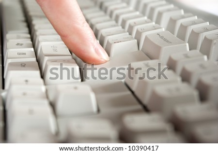 Fingers type a text on the computer keyboard