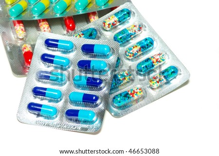 white and colored packs pills on white