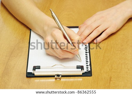 pen in hand isolated on wood background