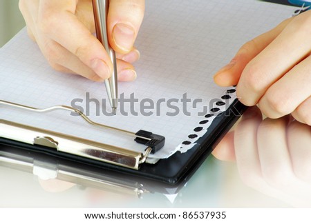 pen in hand isolated on wood background
