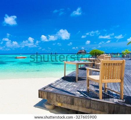 Maldives with few palm trees and blue lagoon