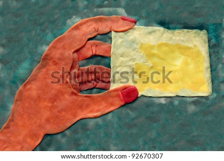 clay hand holding blank name card for your text