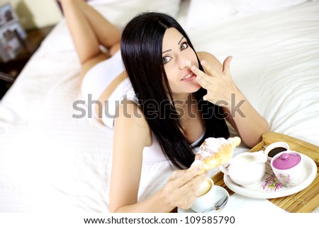 funny face of gorgeous female model with dirty nose during breakfast in bed