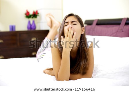 Beautiful woman laying in bed tired ready to sleep