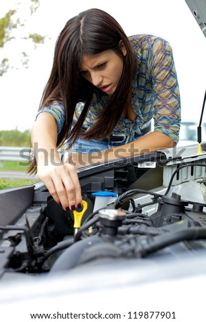 Car with broken engine with beautiful female model