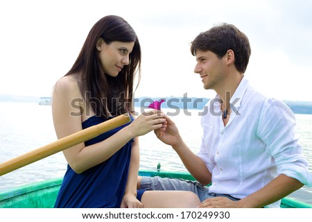 Happy woman receiving romantic present from handsome man