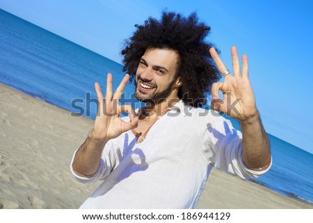 Cool young man happy smiling on the beach in summer in Italy