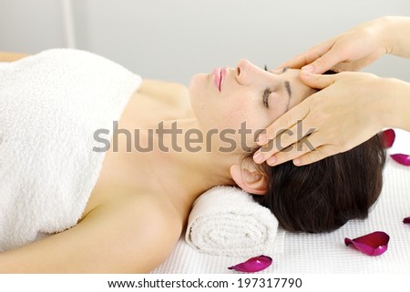 Gorgeous female model getting massage on forehead