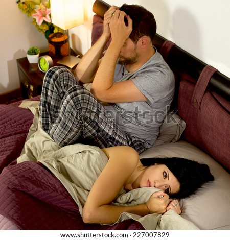 Angry wife and husband not talking in bed