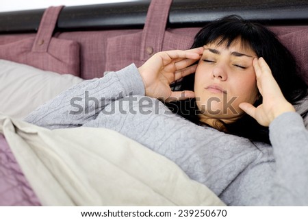 Young woman feeling very sick in bed