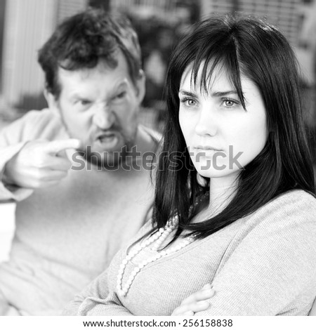 Serious woman not taking care of angry husband