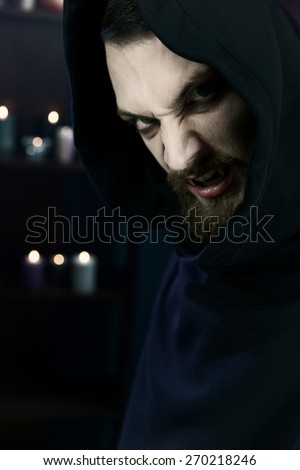 Horror male vampire hungry with candles in background