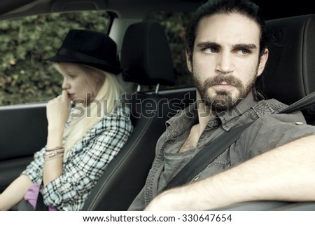 angry man mad at woman after fighting, sitting in car