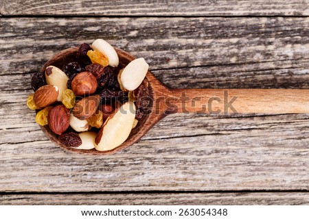 Mixed nuts on a wooden background.