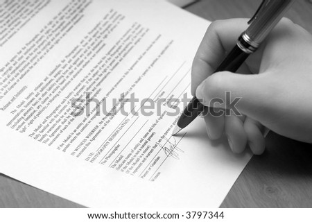 The woman signs the document
