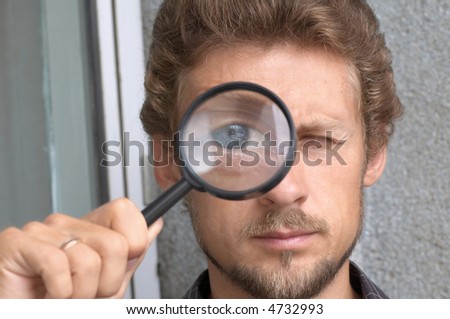 Young man with a magnifying glass