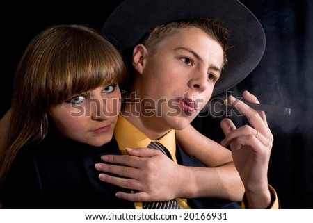 An image of woman and man with cigar in dark room
