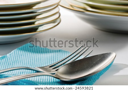 Stock photo: an image of silver spoon and fork on blue napkin