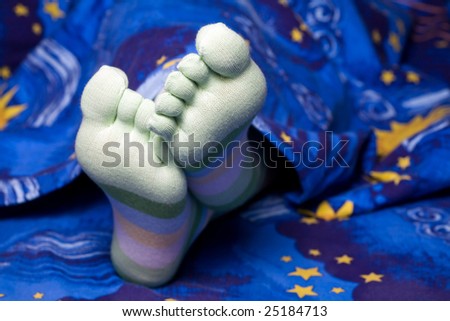 Stock photo: an image of funny feet in striped socks