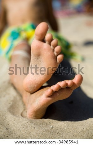 An image of little feet on the sand