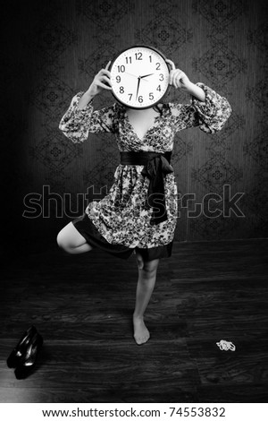 An black-and-white image of a woman with a big clock