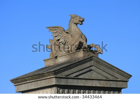 Architectural details of an ancient stone Pegasus sculpture.