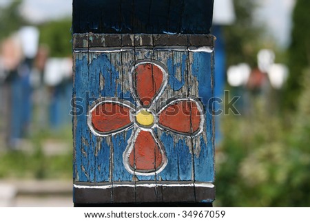 Ornamental details on a painted cross in Merry cemetery from Sapanta-Maramures country (Romania, Europe) - selective focus.
