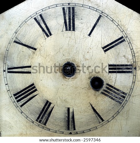 Old antique clock face with hands removed close-up detail. Cracklequere finish to face.