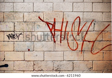Graffiti spray-painted on to a brick wall.