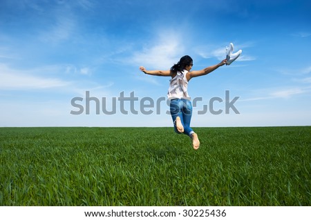 Woman jumping around feeling very happy and free