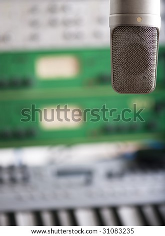 Microphone with studio gear in the  background